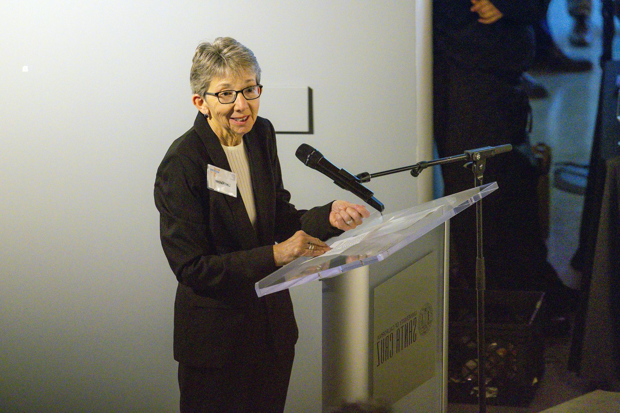 Lori Kletzer speaking at a podium