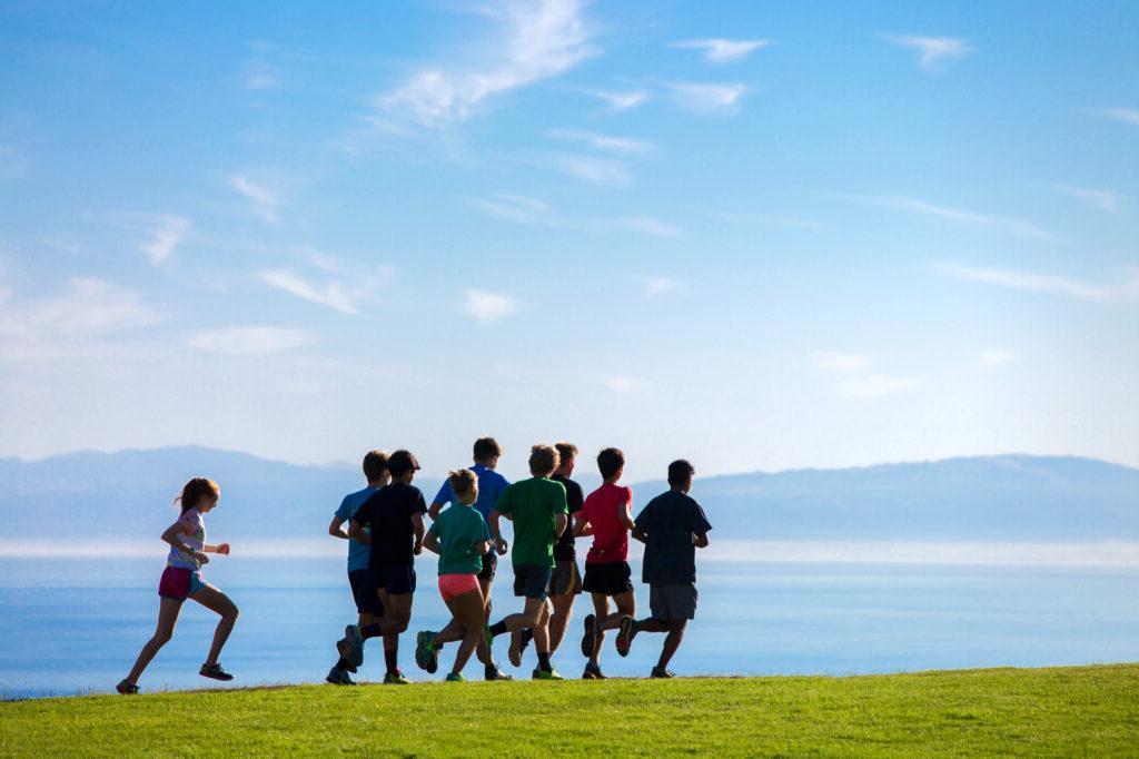 Students running on the East Field over looking the Monterey Bay.
